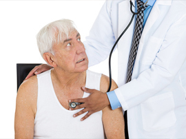 a doctor checking old man's heart beat