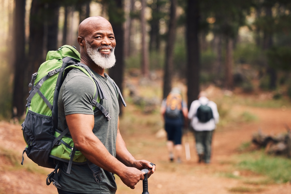 Portrait, black man and hiking in forest, exercise and fitness for wellness